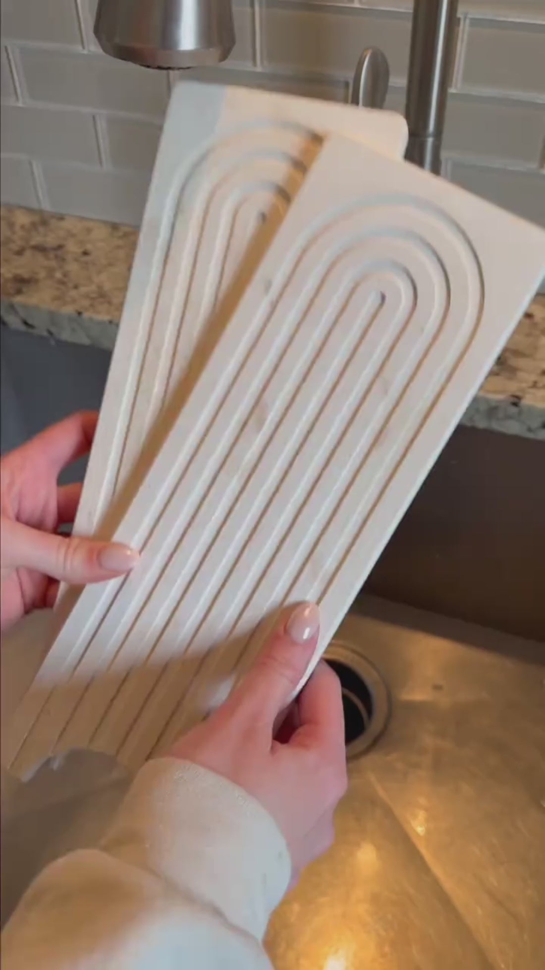 Marbelle diatomite faucet mat absorbing water around the tap